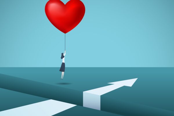 Arrow on the ground with person holding a heart shaped balloon