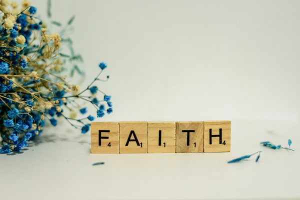 scrabble letters spelling FAITH