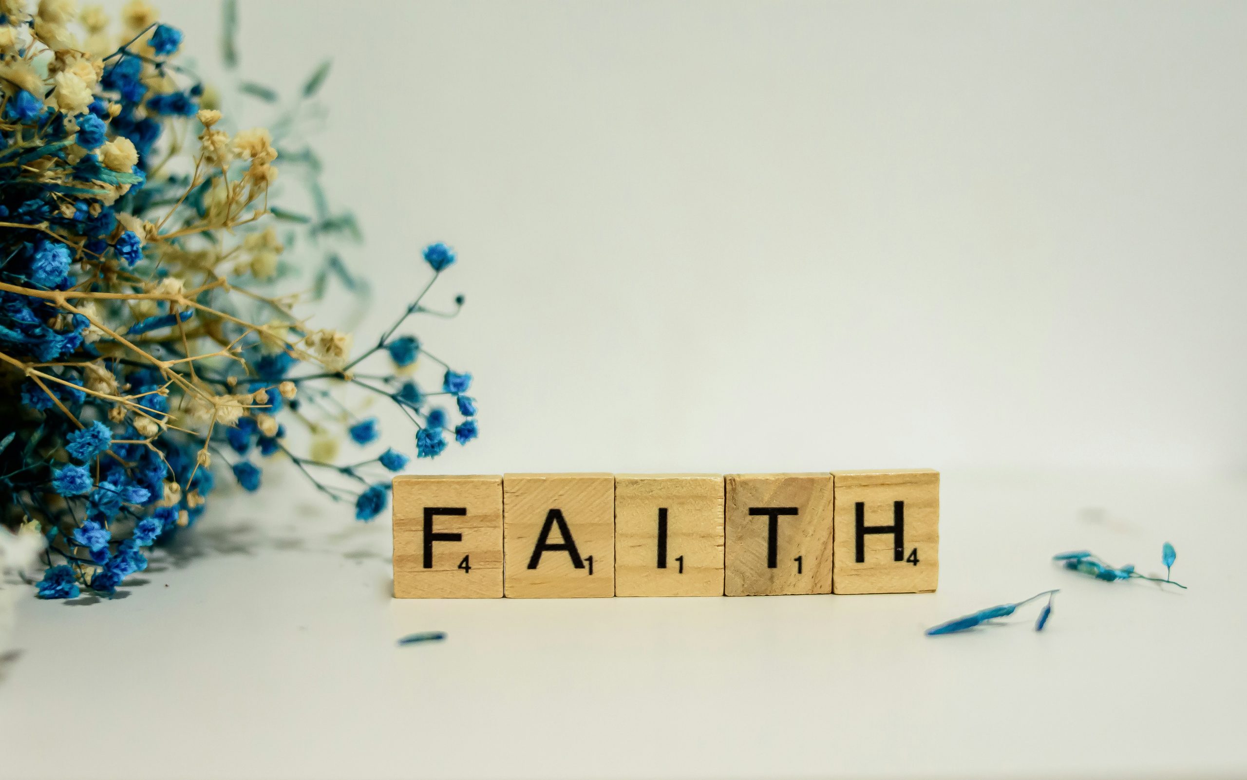 scrabble letters spelling FAITH